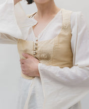 Load image into Gallery viewer, Close up photo of the vest and tunic (entari). modle has one are mat waist and one raised to head highlighting the belled sleeves of the entari (tunic)