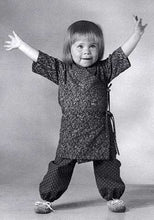 Load image into Gallery viewer, Black and white photo of toddler wearing the Nepali Chupa top and Turkish Bloomers.