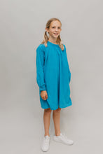 Load image into Gallery viewer, Photo of young girl wearing a blue corduroy Smock. Model is standing in front of a white background looking towards camera.