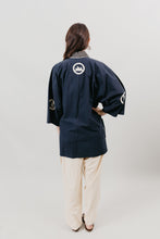 Load image into Gallery viewer, Japanese American woman in a navy Hippari and cream pants standing in front of a white background.
