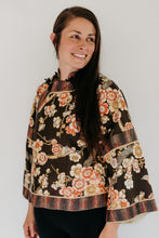 Load image into Gallery viewer, Woman in Floral 114 Chinese Jacket View A. Standing in front of a white backdrop looking over her left shoulder.