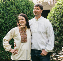 Load image into Gallery viewer, Woman and man standing outside with hedges behind them. Woman is wearing embroiders View B and man is wearing plain white View B. The are standing side by side with arms around eachother.