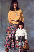 Load image into Gallery viewer, Woman and Child wearing 120 Navajo Blouse and Skirt. Child is standing in front of woman holding a small drum.