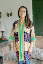 Load image into Gallery viewer, Asian woman wearing a purple, black, green, and gold printed Haori standing on a porch.