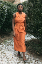 Load image into Gallery viewer, Young woman walking outdoors with snow covered ground wearing 131 Tibetan Chupa jumper.
