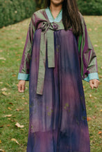 Load image into Gallery viewer, Woman wearing a purple shot silk han bok dress and jacket. Jacket is of teal and green shot silk and tied in the front. She is outside in a lawn. Photo is close up of the front of the hanbok..
