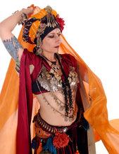 Load image into Gallery viewer, Belly dancer in coin bra and headdress and tassels and scarves. Colors are orange and red.