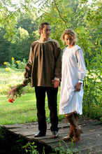 Load image into Gallery viewer, Young white man holding flowers and woman standing on a bridge surrounded by greenery wearing the 148 Black Forest Smock.