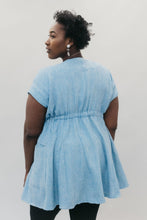 Load image into Gallery viewer, Back view of young African American woman with head looking over her shoulder wearing the women's Ghanaian Smock.