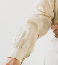 Load image into Gallery viewer, Close up photo of sleeve pleats and cuff.