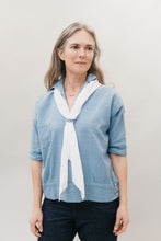 Load image into Gallery viewer, A white woman standing in front of a studio white backdrop wearing the 211 Two middies v-neck with a contrasting scarf through the tab below the v-neck