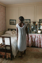 Load image into Gallery viewer, Back view of African women standing next to a bed wearing 223 A Lady's Chemise.