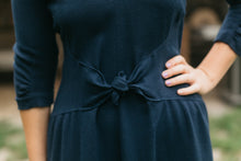 Load image into Gallery viewer, Close up of the front bodice and skirt gathered into a curved midriff that tied at center front, created a snug individual fit.