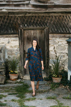Load image into Gallery viewer, woman walking on a stone pathway in front of a old wooden door wearing 247 Lindy Shirtdress.