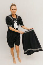 Load image into Gallery viewer, White blonde woman wearing 253 Vintage Bating costume romper and while holding the skirt to the side.