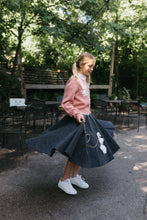 Load image into Gallery viewer, Young blonde girl twirling surrounded by greenery and chairs behind her, wearing At The Hop skirt and Sweater.