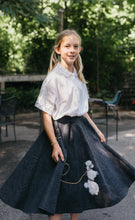 Load image into Gallery viewer, Young blonde girl wearing blouse and skirt of #256 At The Hop surrounded by greenery.
