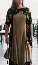 Load image into Gallery viewer, White woman wearing the Promenade Dress showing the attached bib shaped overdress.