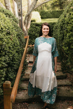 Load image into Gallery viewer, Young Brunette woman smiling walking down steps surrounded by greenery wearing the #261 Paris Promenade Dress.