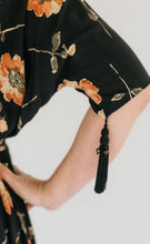 Load image into Gallery viewer, Close up of the sleeve of the Promenade Dress with the decorative cord hanging from the sleeve.