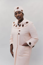 Load image into Gallery viewer, Black woman wearing a pink wool coat with brown leaf applique and embroidery on cuffs and collar and hat.