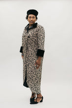 Load image into Gallery viewer, Black woman wearing brown and black coat with black cuffs and high collar.