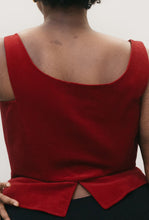 Load image into Gallery viewer, Close up back view of Black woman with shorter curly hair, wearing red #267 M' Lady's Corset with a scoop neck and black pants, standing in front of a studio white backdrop with her left hand on her hip showing how the pattern can be made for a DIY corset top. Romantic and sexy.