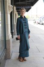 Load image into Gallery viewer, Young blonde white woman standing outside of a shop with her knee bent wearing the Metropolitan Suit.