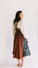 Load image into Gallery viewer, Back view of model looking back over her right shoulder. Model is wearing blouse, jumper, and apron all together.