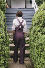 Load image into Gallery viewer, Back view of young woman walking wearing the 240 Rosie the Riveter Overalls.