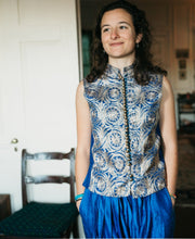 Load image into Gallery viewer, Woman wearing a blue and white patterned vest from the Algerian Suit indoors.