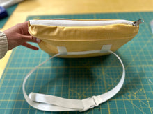 Load image into Gallery viewer, yellow poncho zippered pouch with a waist band.