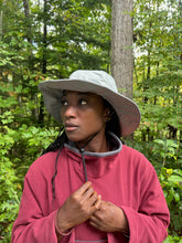 Load image into Gallery viewer, Woman wearing a grey hat and red fleece sweater in a fores setting.