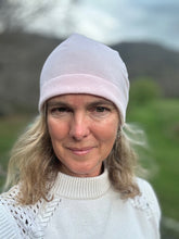 Load image into Gallery viewer, Head shot of woman standing outside wearing a pink beanie. Front view