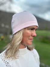Load image into Gallery viewer, Head shot of woman standing outside wearing a pink beanie. Side View