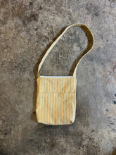 Load image into Gallery viewer, Small striped bag on a textured gray surface