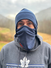 Load image into Gallery viewer, Person wearing a blue balaclava and gray hoodie with a logo, standing outdoors.