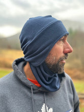 Load image into Gallery viewer, Man wearing a blue headscarf outdoors with a blurred natural background