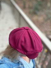 Load image into Gallery viewer, Person wearing a maroon cap with a blurred background - view of top of cap