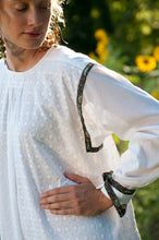 Load image into Gallery viewer, Close up of the sleeves connected to the side panels with gussets that are pleated at the wrists.