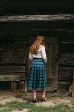 Load image into Gallery viewer, Photo of the back view of the kilt skirt on young woman walking.