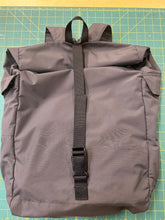 Load image into Gallery viewer, Gray bag with a black strap on a green cutting mat