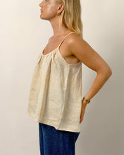 Load image into Gallery viewer, Woman wearing a beige sleeveless top and blue pants against a plain background