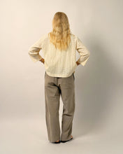 Load image into Gallery viewer, Person wearing a beige shirt and gray pants against a plain background
