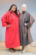 Load image into Gallery viewer, An African American woman on the left, and a Caucasian woman on the right. Both are wearing the Basics Overcoat. One in Scarlett Red and the other is a wool chocolate brown.