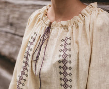Load image into Gallery viewer, Close up photo of the Romanian Blouse neckine.  Shows gathers and drawstring closure as well as embroidery on chest.
