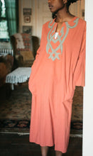 Load image into Gallery viewer, Full view of model in 104 Egyptian top leaning on door frame.
