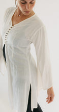Load image into Gallery viewer, Model wearing the single layer of the Entari (tunic). Photo shows side slit and front closure/ opening.
