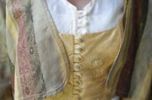 Load image into Gallery viewer, Close up photo of the front of jacket over vest and tunic as under layer.  Closures of vest and jacket are the focus of the photo.
