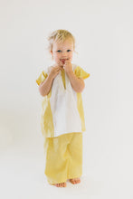 Load image into Gallery viewer, Small child wearing a yellow and white Turkish tunic and yellow pants.
